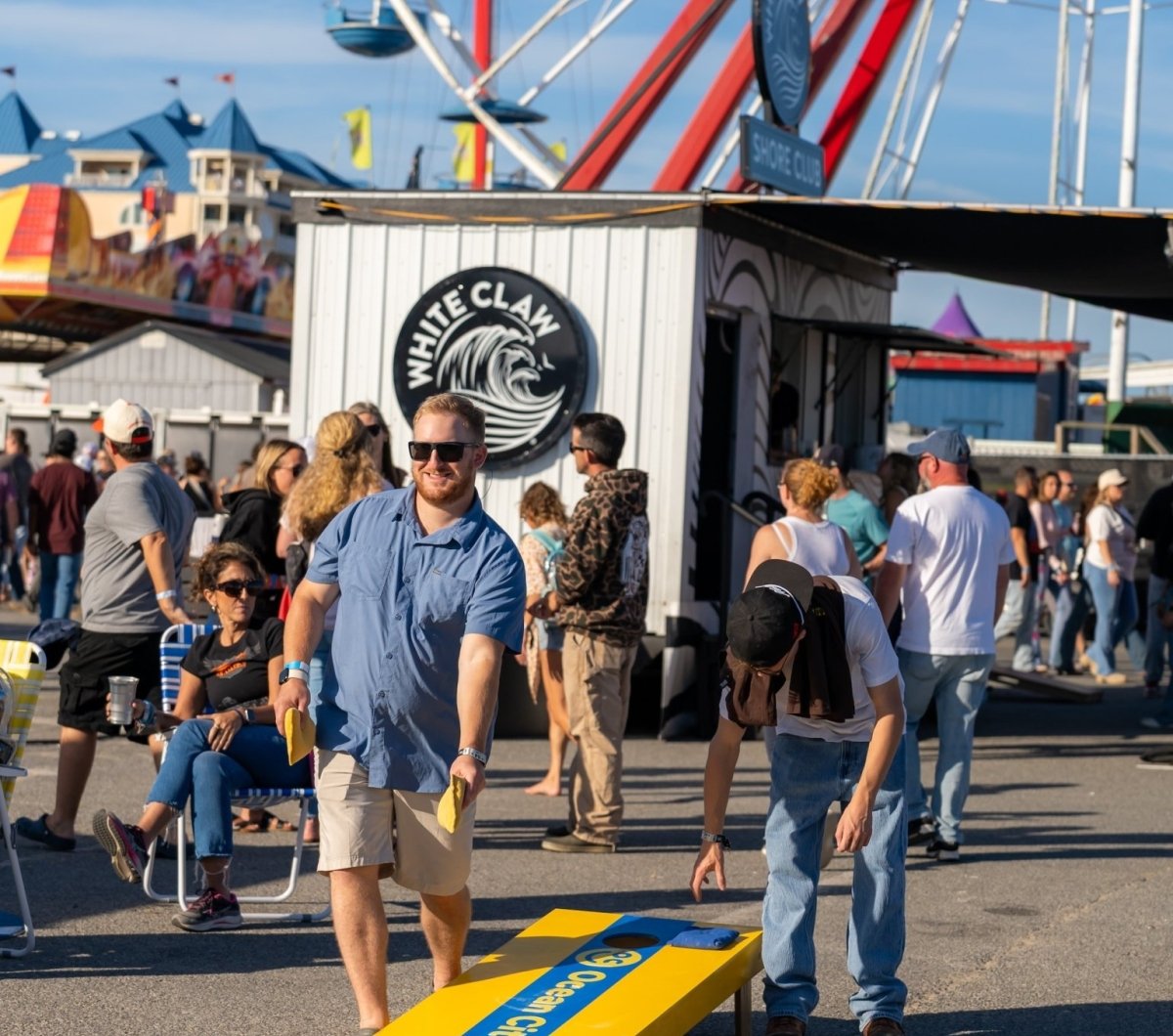 Country Calling Cornhole playing cornhole at Country Calling